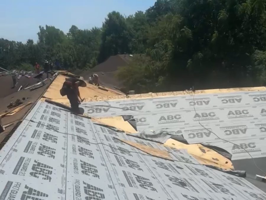 Pinnacle Restoration crew mid tear-off with underlayment being installed